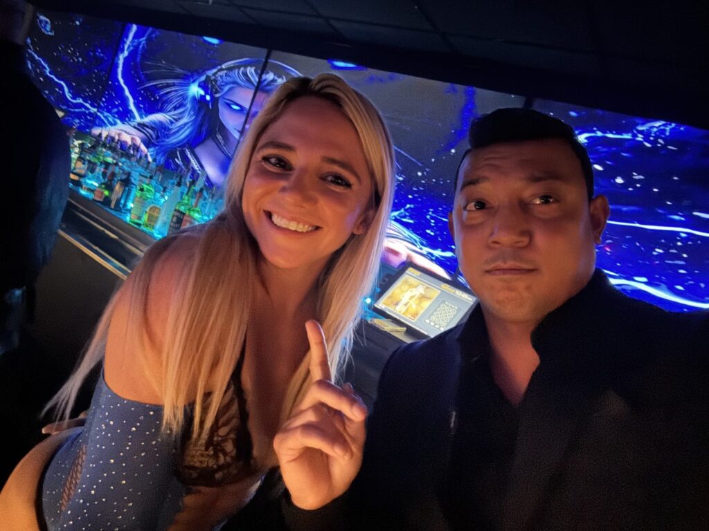 Guests at the bar beneath the LED art wall at Dancers Royale, Orlando