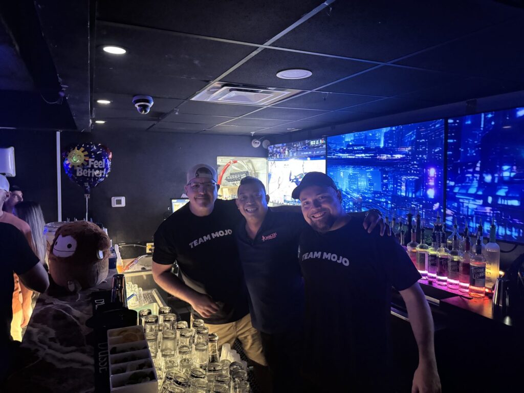 Staff and guests behind the full bar at Dancers Royale, Orlando