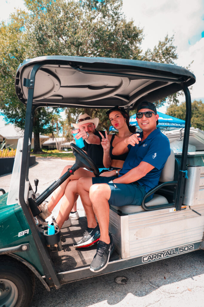 Golfers having fun in their cart at the Dancers Royale charity golf event